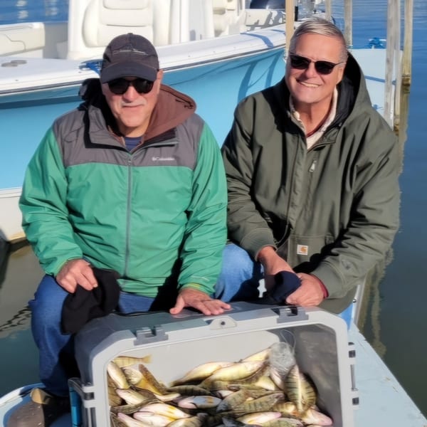 Group with Erie Gold sign and full catch rack